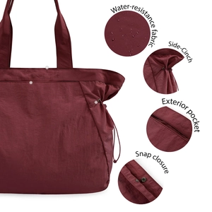 Detail view of water-resistant fabric, side-cinch, exterior pocket and snap closure on tote bag