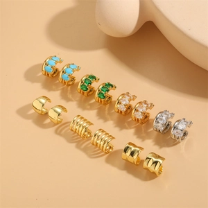 Fashionable gold and silver ear cuff set with emerald zircon and textured finish