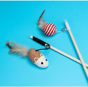 Detail of wooden cat wands with feathers, bells, and plush mouse on blue background