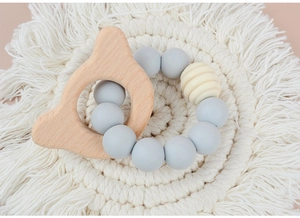 Detail of baby teething bracelet with natural beech wood and grey silicone beads
