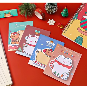 Flat lay of Christmas stationery set with cute bear sticky notes and festive tape