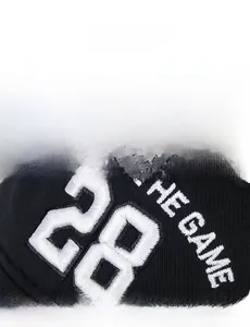 Close-up of white 28 embroidery and the game text on black cotton baseball cap