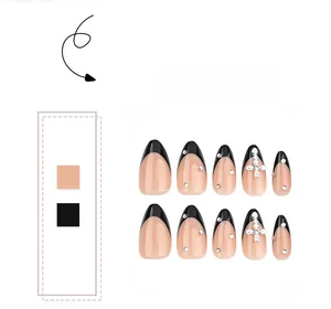 Detailed view of almond-shaped black French press-on nails with silver cross and rhinestones