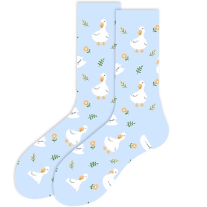 Detail of light blue knit socks featuring cute cartoon ducks and small flower patterns