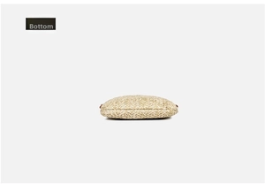 Detailed bottom view showing the flat oval woven structure of the straw beach bag