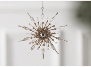 Detail of transparent acrylic snowflake pendant with gold glitter and central gemstone