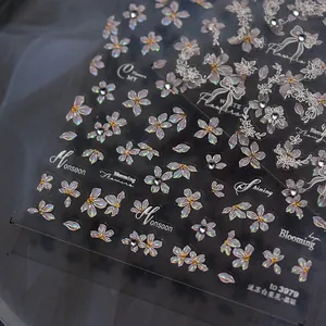 Detailed macro view of 3D white pear flower nail stickers with sparkling crystals