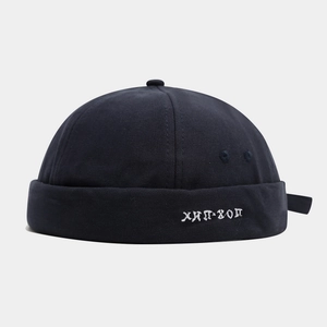 Detailed close-up of navy blue hip-hop docker cap featuring white letter embroidery