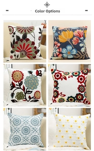 Detail view of six floral and geometric embroidered cushion covers in various colors