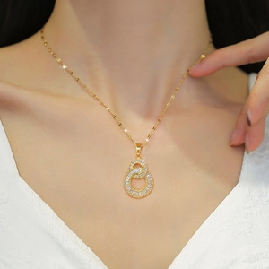 Interlocked double ring pendant necklace in gold with sparkling zircons worn by model
