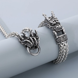 Detail of vintage titanium steel dragon head bracelet with thick double-row curb chain