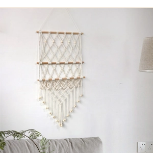 Close-up of bohemian woven tapestry shelf with three tiers and elegant fringe tassels