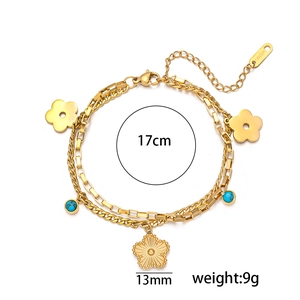 Double-layered 18k gold plated bracelet with flower charm and blue gemstone detail