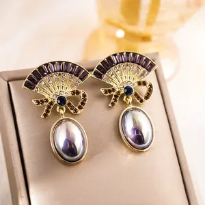 Retro fan-shaped gold earrings with purple rhinestones and large oval pearl drops