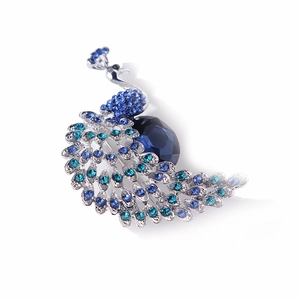 Detailed view of peacock brooch with blue crystal rhinestones and silver alloy base