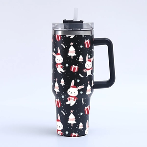 Close-up of 40oz Christmas tumbler featuring cartoon bunnies and festive trees on black finish