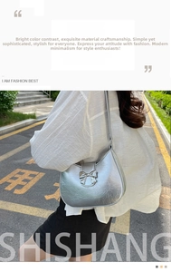 Close-up of silver hobo bag with bow detail and crinkled texture on shoulder strap
