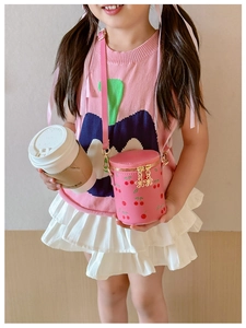 Pink cherry bucket bag for girls featuring a cute print and gold chain strap close-up