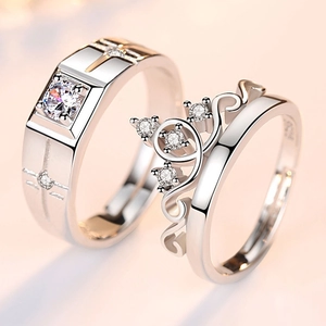 Macro shot of S925 silver couple rings featuring a crown design and sparkling zircon stones