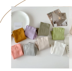 Flat lay of eight colorful pastel cotton socks neatly arranged on a white surface