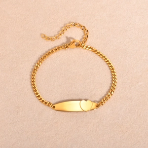 Macro shot of 18K gold plated stainless steel bracelet with engraved heart charm