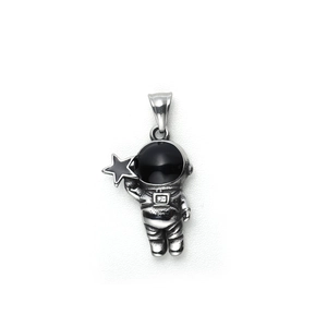 Macro shot of polished steel astronaut pendant holding a star with black glossy visor