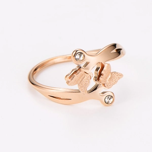 Detail of rose gold butterfly ring featuring matte wings and sparkling crystal accents