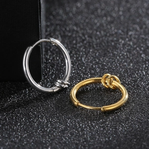 Macro shot of silver and gold stainless steel hoop earrings with coiled wire details