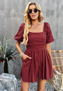 Close-up of wine red square neck romper with puff sleeves and waist pleat detail