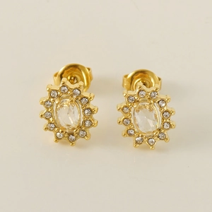 Golden stainless steel sunflower stud earrings with oval cubic zirconia on beige background