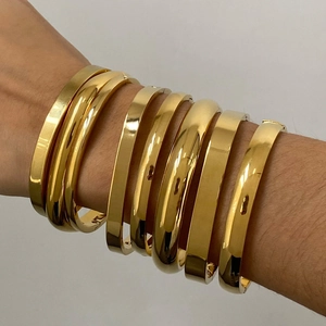 Polished gold stainless steel stackable bangles in various widths for a minimalist style
