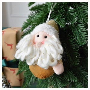 Detail of plush Santa Claus ornament with curly white beard on a Christmas tree