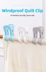 Detail of strong windproof quilt clips in sky blue, white, and grey on a drying rack