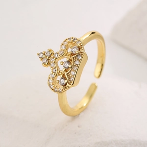 Macro detail of 18K gold plated crown ring featuring sparkling white cubic zirconia