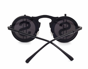 Detail of round punk sunglasses with dollar sign print on dark black lenses