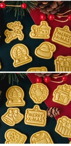 Close-up of baked Christmas cookies in shapes of reindeer, sleigh and bells on a festive background
