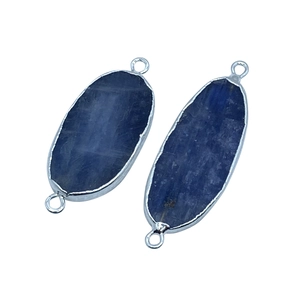 Detailed macro of two silver-edged blue kyanite oval connectors for DIY jewelry making