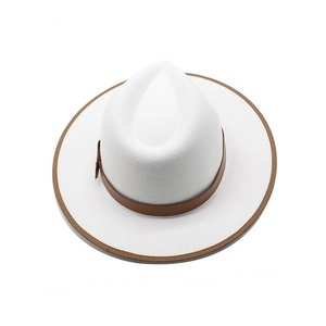 Top view of white wool fedora hat featuring a brown leather strap and bound edge detail