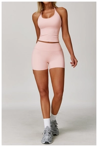 Halter neck cropped top and high-waist shorts in light pink stretch yoga fabric