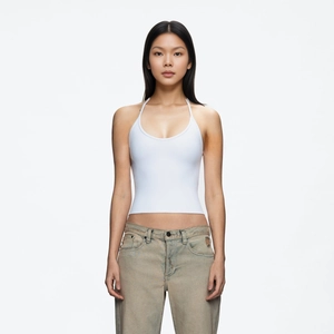 Close-up of white slim fit U-neck tank top paired with light wash denim jeans