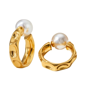 Minimalist C-shaped gold textured pearl earrings with elegant hammered metal finish