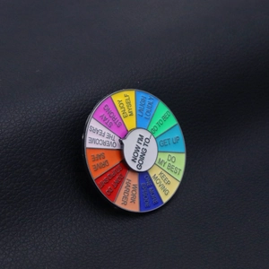 Detail of colorful spinning enamel pin with social battery and mood tracking dial