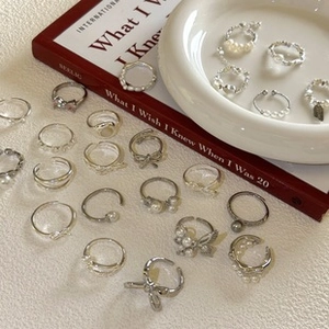 Detailed flat lay of 925 sterling silver ring set featuring pearls and crystals