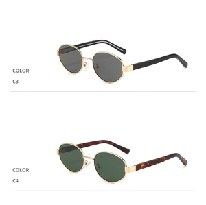 Detail view of retro oval sunglasses showing gold metal frames in black and tortoiseshell
