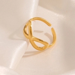 Minimalist gold infinity stainless steel ring with elegant twisted design on white silk