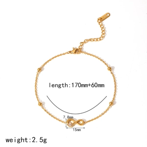 Gold titanium steel infinity bracelet with clear zircon and beads on white background