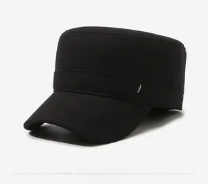 Detailed side view of black wool flat top cap with shield-shaped metal logo emblem