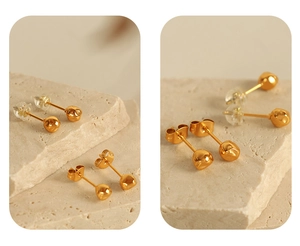 Detailed view of gold irregular stud earrings with replacement backings on stone