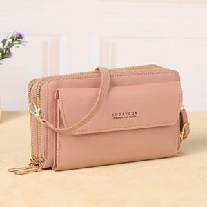 Detailed view of the dusty pink crossbody phone bag with gold zippers and PU leather texture