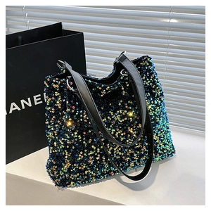 Macro detail of multi-color sequins on a large tote bag with black double handles